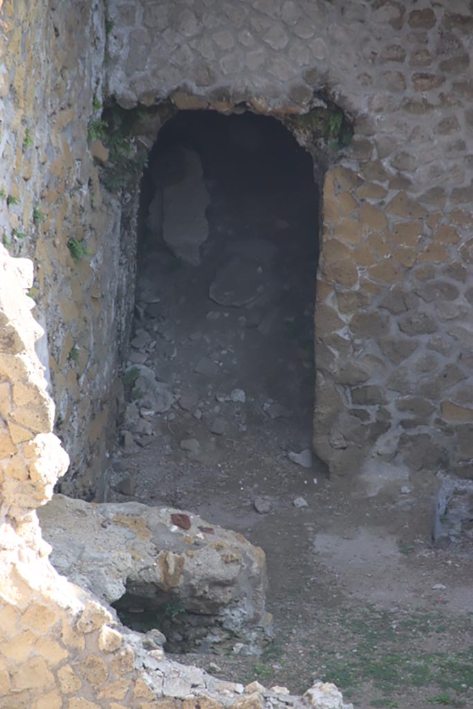 III.1/2/18/19, Herculaneum, October 2023.
Doorway in north wall of room G, with remains of oven/hearth against west wall.
Photo courtesy of Klaus Heese.